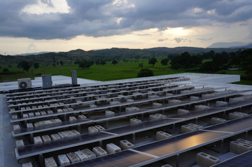 In order to maximize energy production, researchers from the University of Oregon provided sun charts: that showed how to best position the panels. Though Haiti’s ample sunshine is what powers the hospital, the scorching temperature of a sunbaked roof could actually cause the panels to produce less electricity. To work around this conundrum, engineers floated the panels about a foot above the roof and added a coat of white paint, which lowers the surface temperature and bounces more sunrays on to the panels. “This is an incredibly simple system to maintain...,” Ansara said. “All we need to do is rinse the panels quarterly with water.” Photograph courtesy of Partners In Health